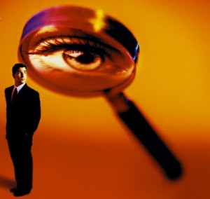 Magnifying Glass Examining Businessman